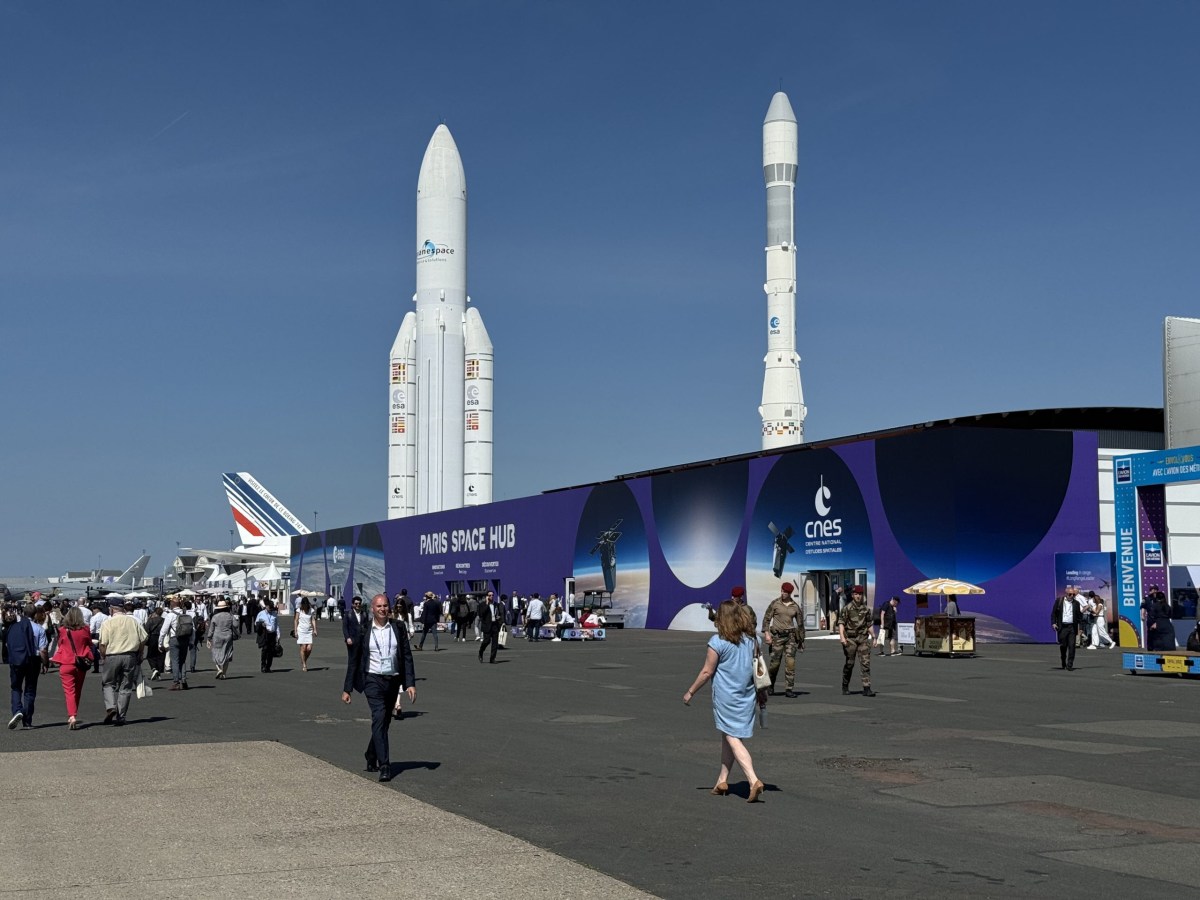 The Paris Air Hub, located next to full-scale models of the Ariane 4 and Ariane 5 rockets, was the central location for space at the Paris Air Show. Credit: Jeff Foust / SpaceNews