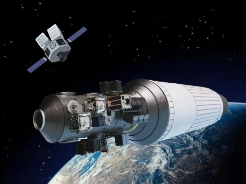 A digital rendering of InfinAstro’s “Space Bus” orbital transfer vehicle in space, carrying multiple small satellites and approaching Earth orbit.