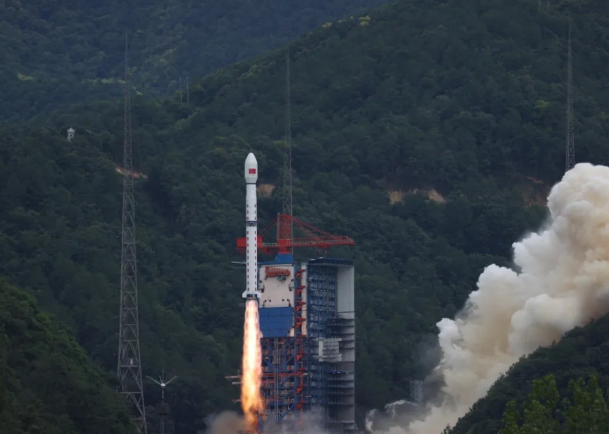 A Long March 4C rocket lifts off from Xichang Satellite Launch Center in a forested mountainous region of southwest China, trailing flames and smoke as it carries the Shiyan-28B (01) satellite into orbit on July 3, 2025.